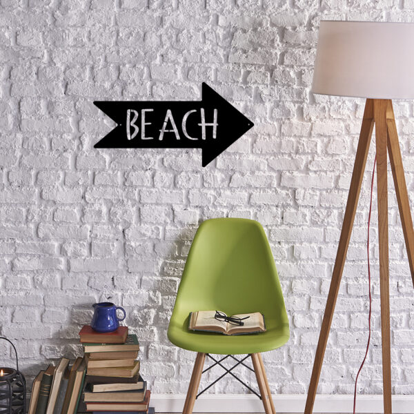 beach arrow sign on wall